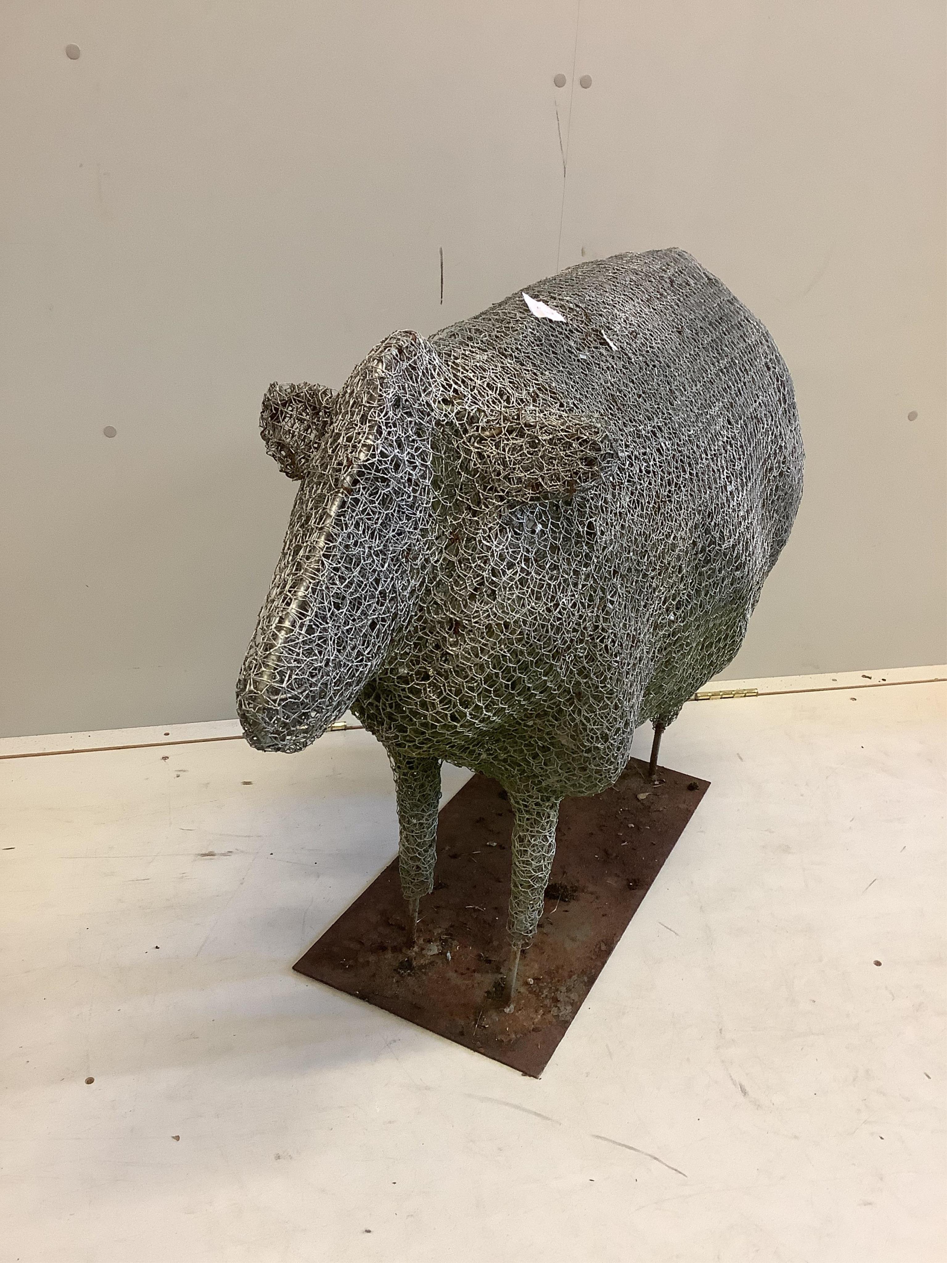 A Rupert Till wire work sculpture of a sheep on rectangular iron stand. Length 100cm, height 75cm. Condition - weathered but fair